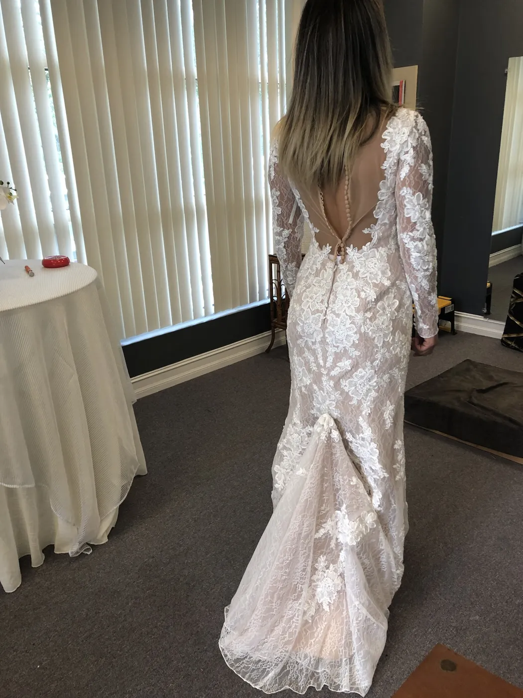 A bride in a fitted lace gown with an open back